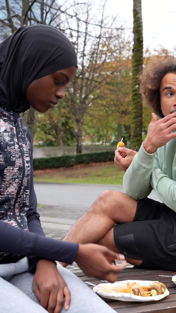 People eating food in the park