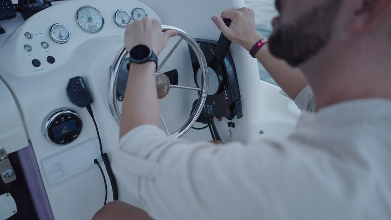 Person steering a boat from the helm