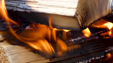 close up of fire burning in a concrete pit in slow motion