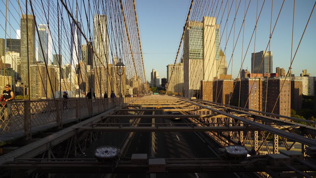 Busy Cars Traffic through Brooklyn Bridge to Lower Manhattan on a Sunny Evening in New York