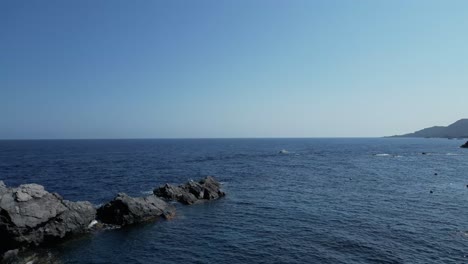 a mesmerizing aerial cinematic capture of cabo de palos, showcasing its crystal-clear ocean waters, rugged coastline, and the serene beauty of this spanish coastal paradise