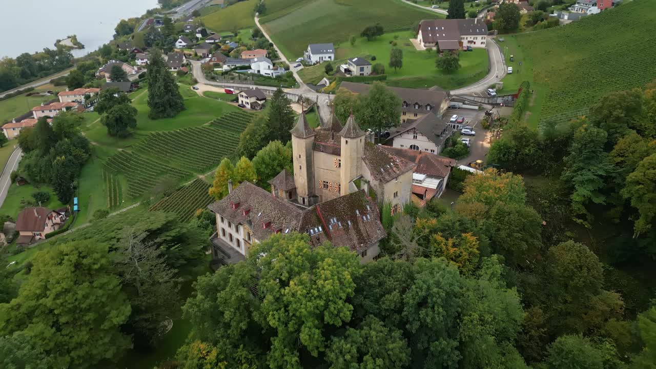 Reveal drone shot behind Vaumarcus Castle in Canton of Neuchatel Switzerland