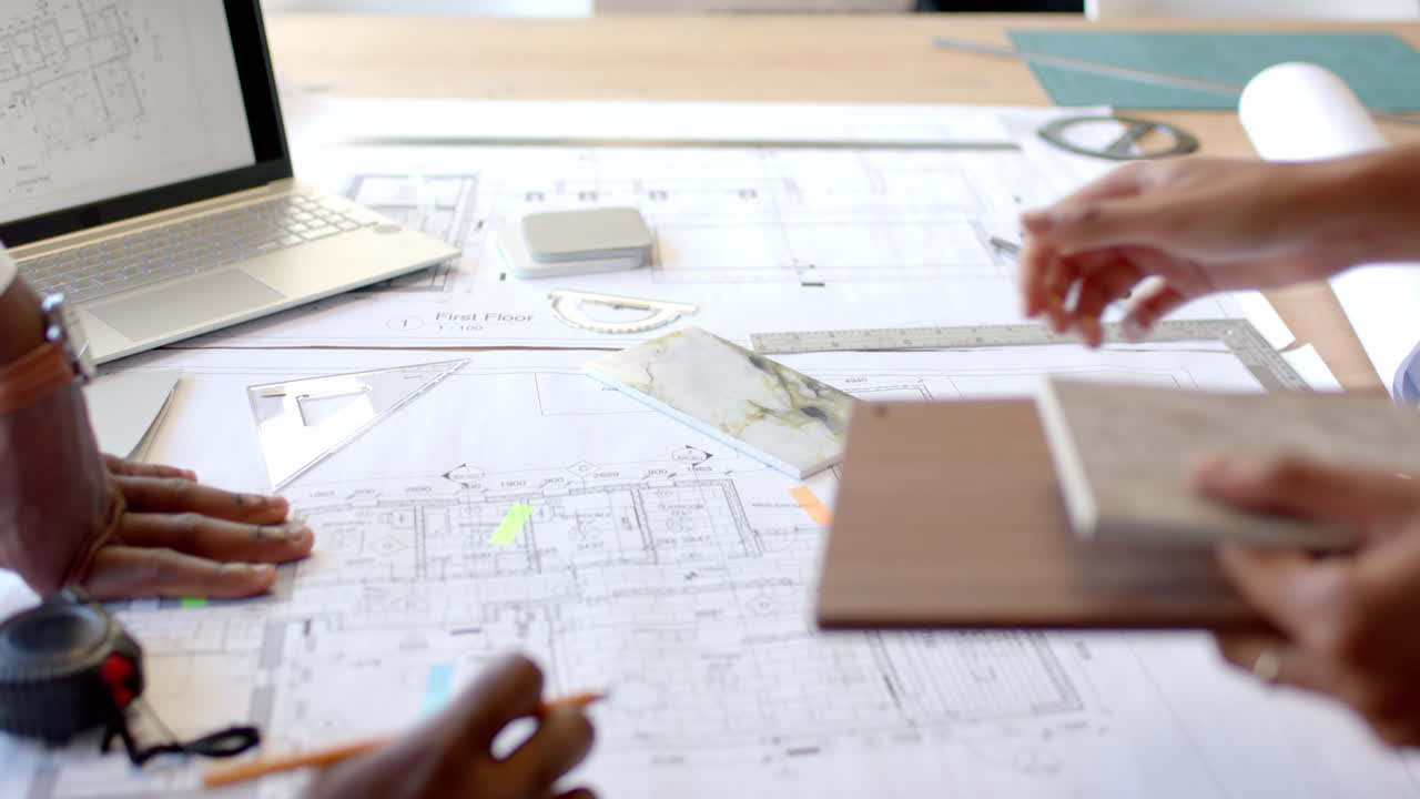 Reviewing blueprints and materials, architects collaborating on construction project