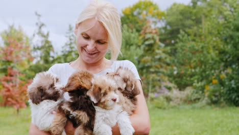 woman holding several puppies