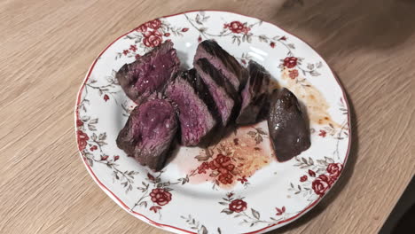 grilled beef steak half finished sliced on a plate