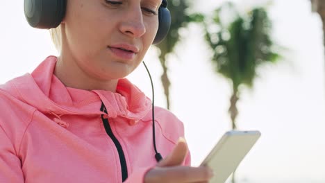 handheld view of woman choosing the best song for running