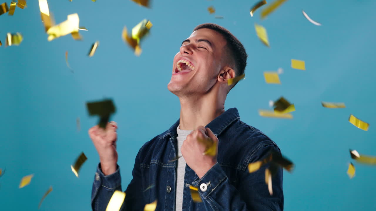 A man celebrates with confetti
