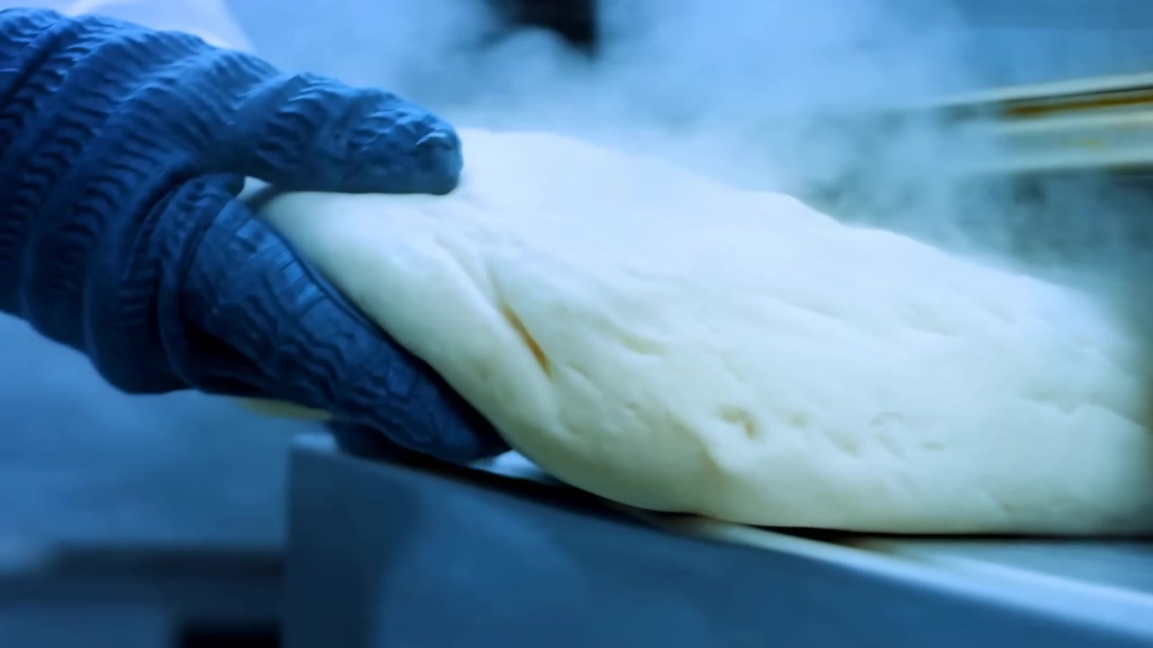 A healthcare professional is performing a procedure on a patient's arm in a clinical setting, using sterile materials. The scene is captured with a focused perspective, emphasizing.