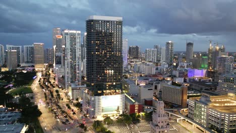 aerial pullback above downtown miami skyscraper skyline shimmering buildings at night