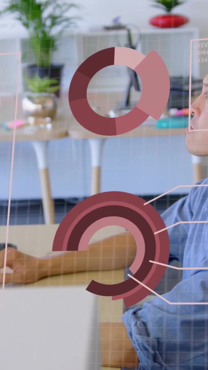 Vertical video: Male analyst moving hand at desk, activating tech charts on screen to analyze data