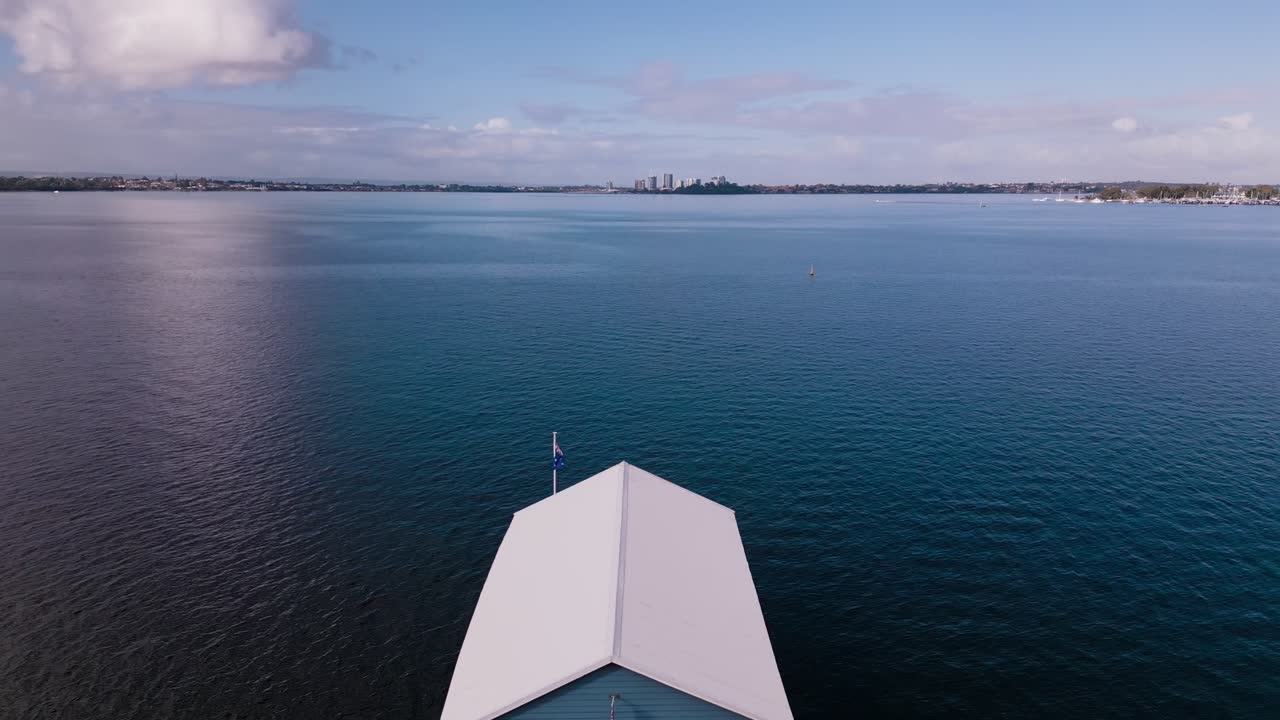 Aerial footage advancing towards the blue boat house and swan river on a winter evening in Perth, Western Australia