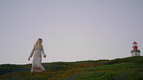 exquisite girl stepping hilltop evening vertical. tender lady walk valley sunset