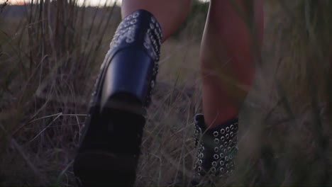 girls feet walking in a field with shallow depth of field follow shot