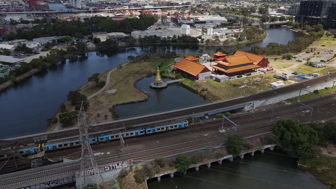 Aerial drone above Metro train in Melbourne on a cloudy day