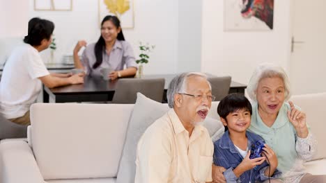 elderly couple and child enjoy video games together, creating joyful family moments in a cozy living room setting