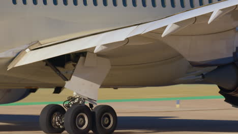 close-up of airplane landing gear and wing