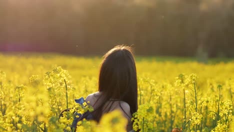 joyful woman in hat dancing on verdant field