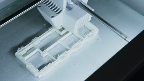 Camera-Pans-over-a-3D-Printer-printing-a-Plastic-Building-model-in-an-Architecture-Firm