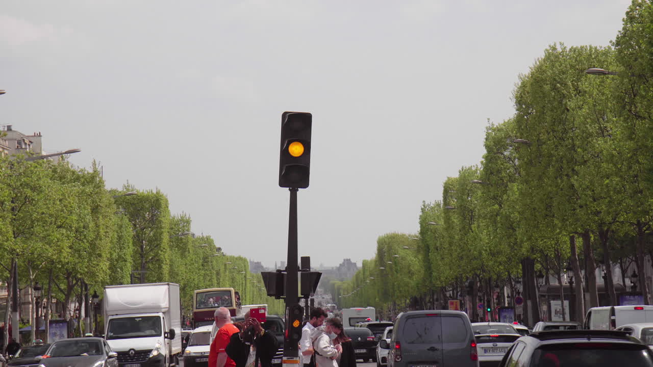 Street Light Heavy Traffic and Pedestrians In Paris Champs Elysees in Paris France 4K
