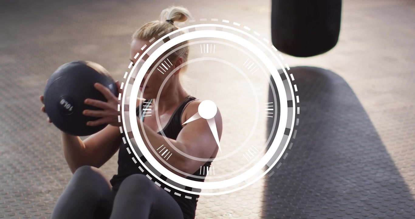 Timer graphic appearing motivating female athlete twisting medicine ball side-to-side interval burn