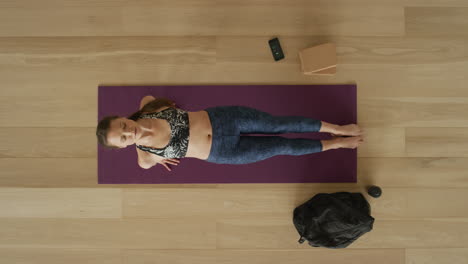 overhead view flexible yoga woman practicing upward plank pose enjoying healthy lifestyle exercising in fitness studio training on exercise mat