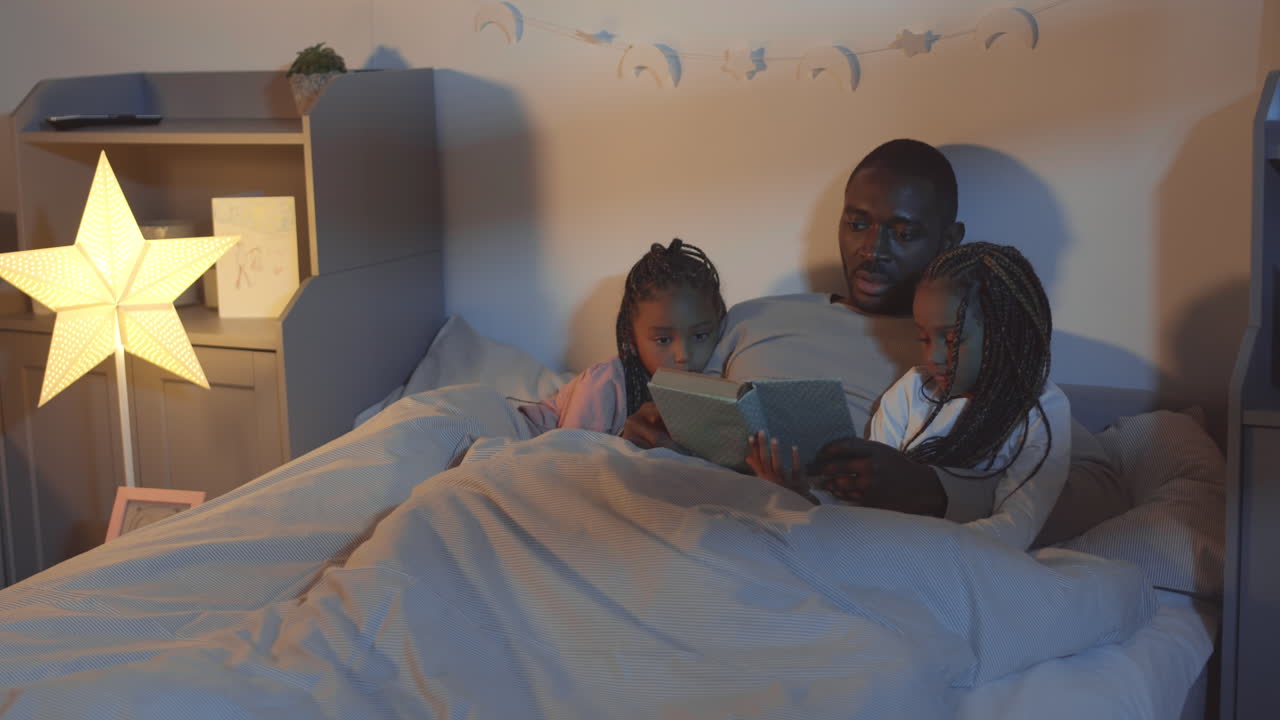 Father Reading Bedtime Story to Girls