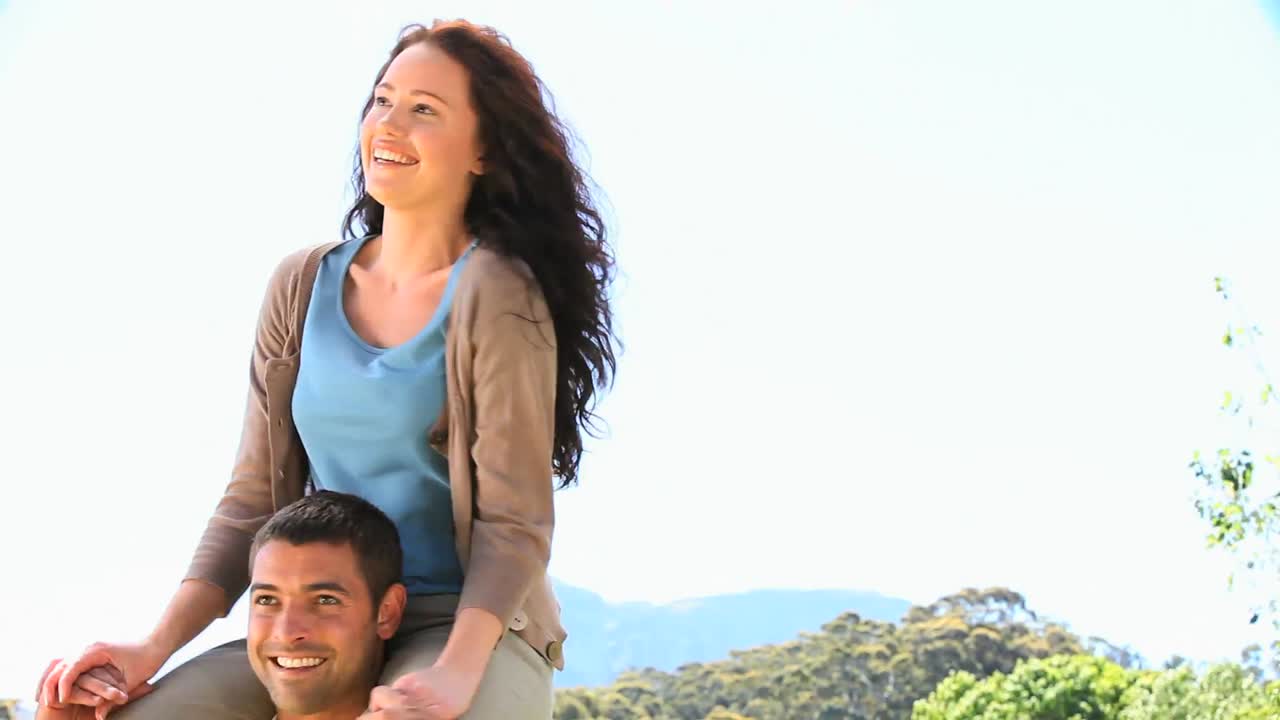 귀여운 남자가 아내를 어깨에  ⁇ 고 있다