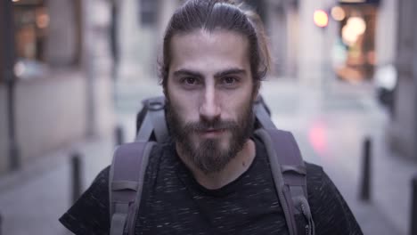 man with backpack in urban setting