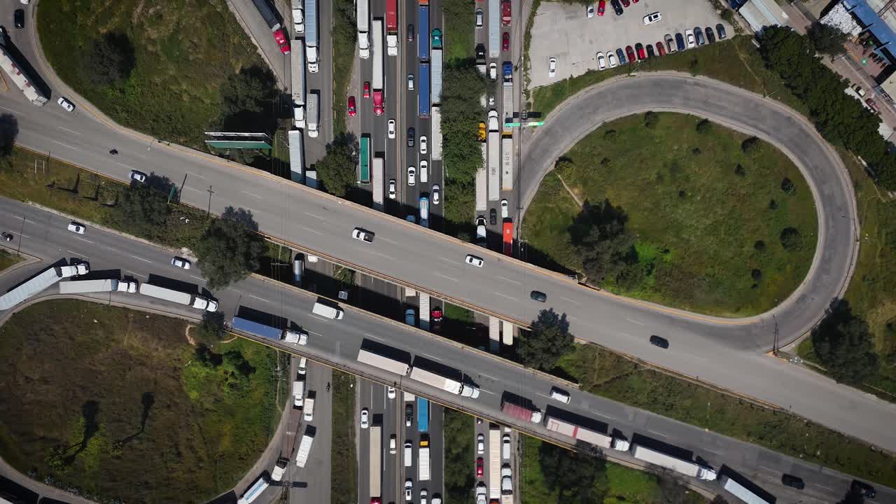 Top-down ascending drone footage of heavy Friday morning traffic on the Mexico-Querétaro highway in Cuautitlán Izcalli, north of Mexico City. Urban congestion and highway aerial view