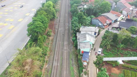 train passing through a residential area in indonesia