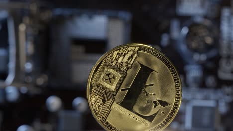 Litecoin-spinning-on-computer-motherboard-background,-cryptocurrency-mining,-virtual-money