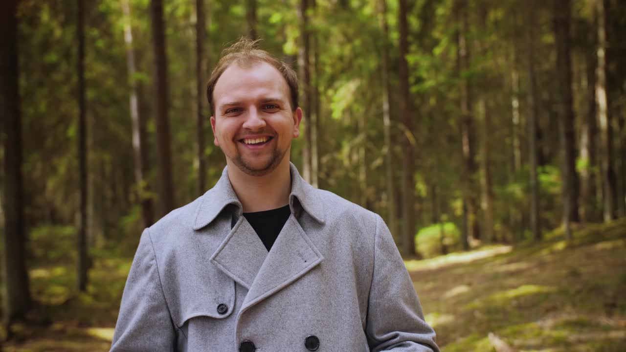 Portrait of young guy in protective white medical mask. Young guy take off a face mask in city park or forest. End of pandemic, Coronavirus.