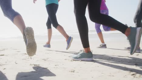 athletic women running on the beach