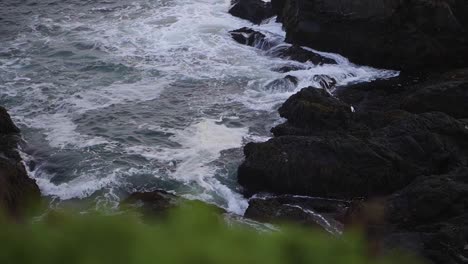 Ocean-waves-crashing-on-a-rocky-shoreline-at-sunset