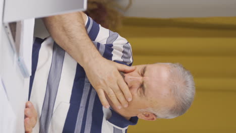 Vertical-video-of-Home-office-worker-old-man-suffering-from-shortness-of-breath.