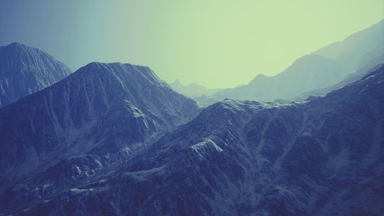 Mountains bathed in soft light revealing textured peaks and valleys