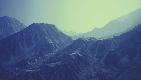 mountains bathed in soft light revealing textured peaks and valleys