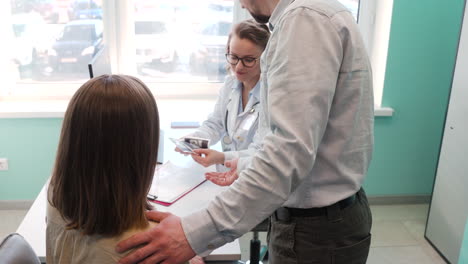 gynecologist showing ultrasound images to her pregnant patient in medical consultation