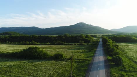 country road through a lush mountain valley