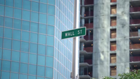 wall street green sign in new york city. new building and building in construction as background. non-conventional wall street sign.