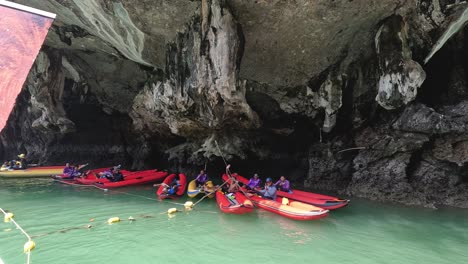 tourists paddling through a serene cave river