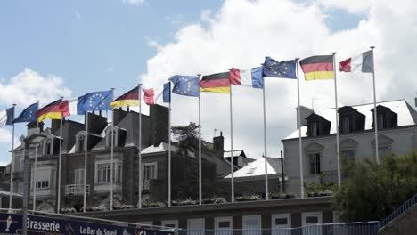 european flags flowing over buildings