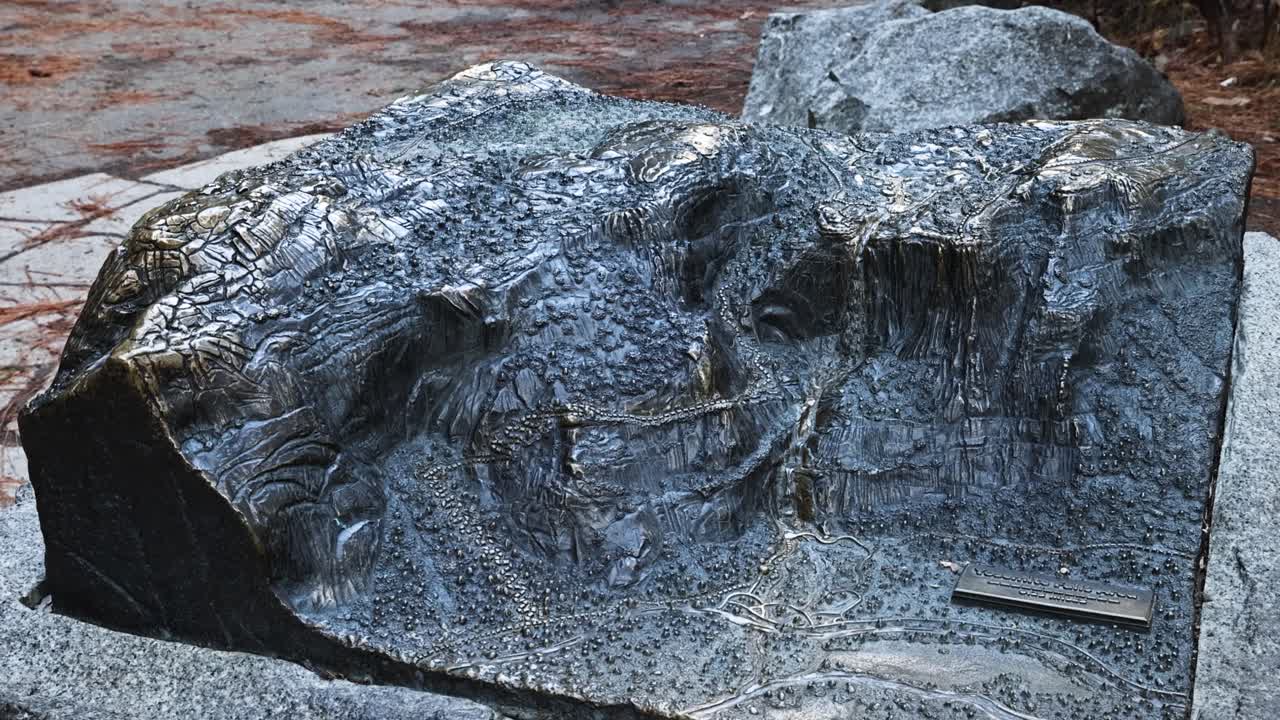 bronze topographical 3d map statue at the base of Yosemite Falls trail in Yosemite National Park TRUCKING RIGHT PAN LEFT