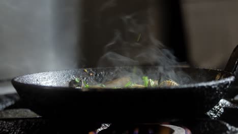 cooking mussels in pan with herbs