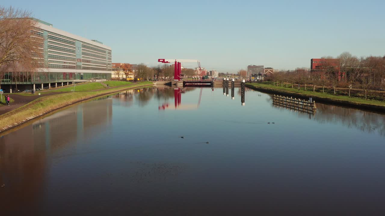 Low to high revealing aerial shot from the city of Middelburg, starting above the canal