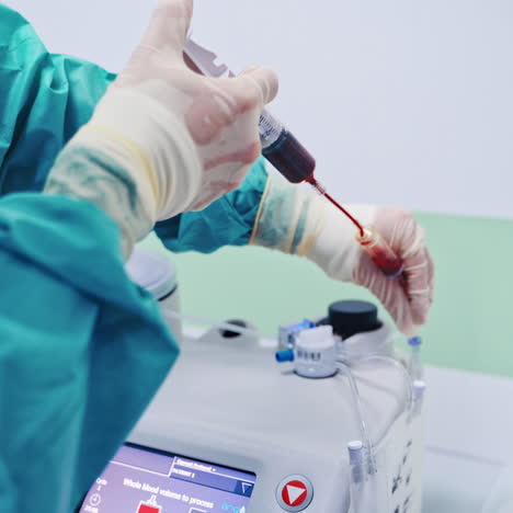 Stem cells injection procedure. Female worker pours blood from syringe into special machine. Modern equipment in clinic.