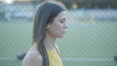 woman jogging on outdoor track in sportswear at athletic field