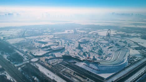 aerial view of the harbin ice festival 2025, showcasing vast ice sculptures, snowy landscapes, and an amusement park under a crisp winter sky. a stunning display of seasonal artistry. china
