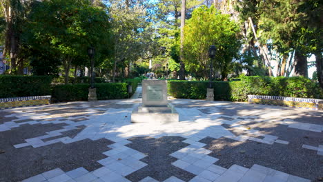 park with a checkered pathway leading up to a central monument or plaque on a pedestal