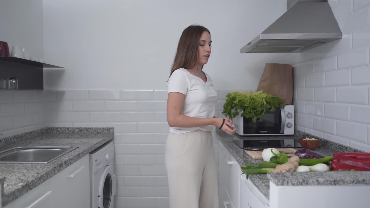 Woman getting ready to cook in a modern kitchen